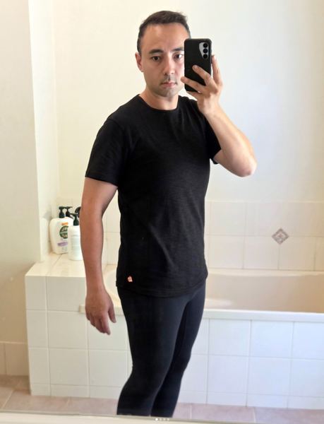 Now: quarter-angle mirror selfie in a black T-shirt